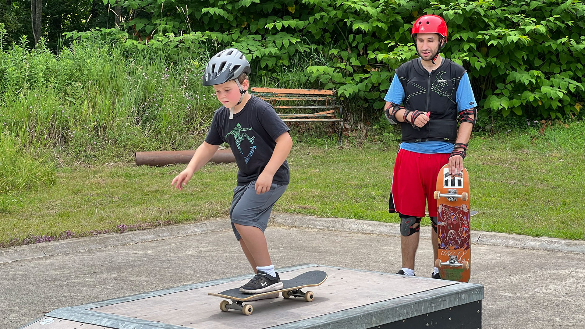 ASF Skateboard Thomas Stratton pushes down a ramp while fellow skateboarder Zach Elder watches
