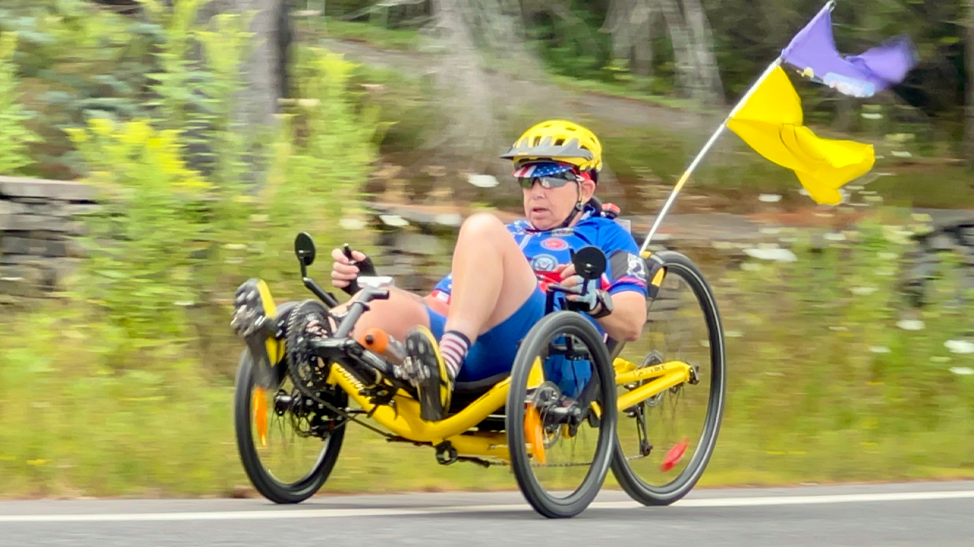 A woman cycling on a recumbent bike