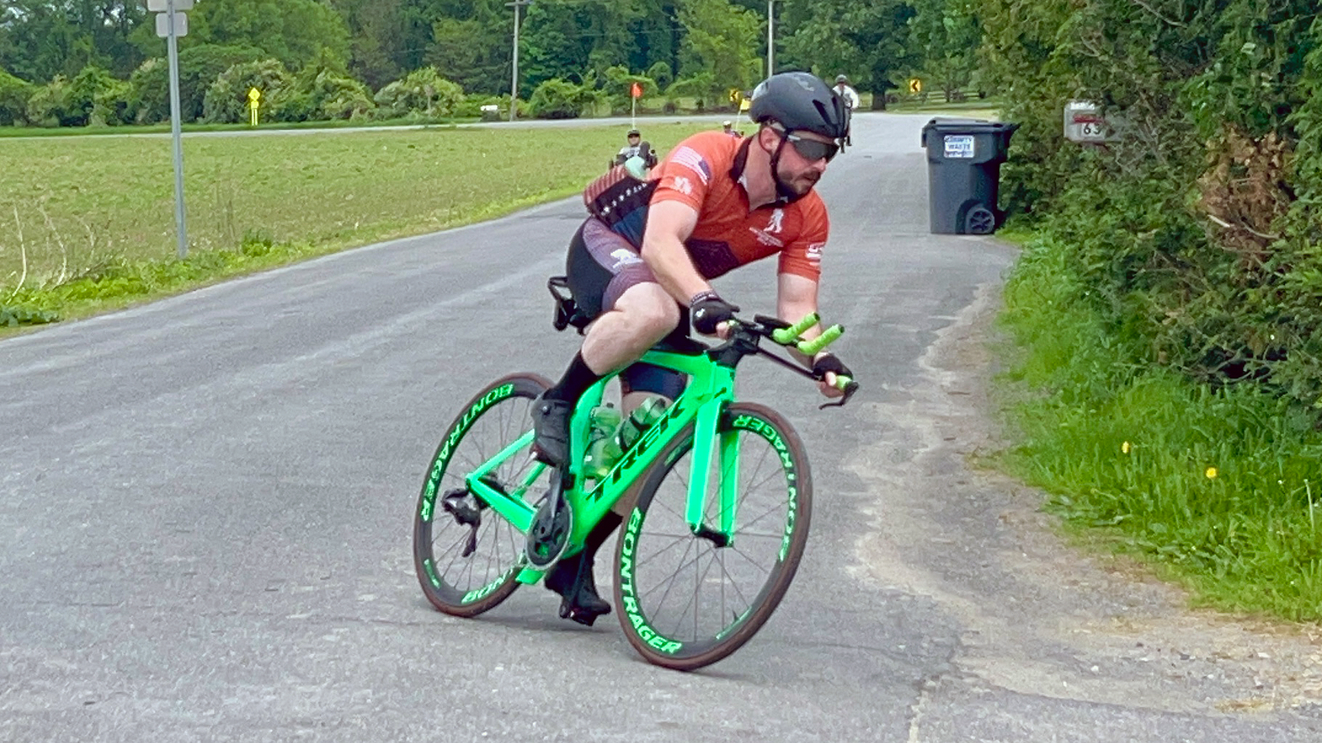 A person riding a green bike