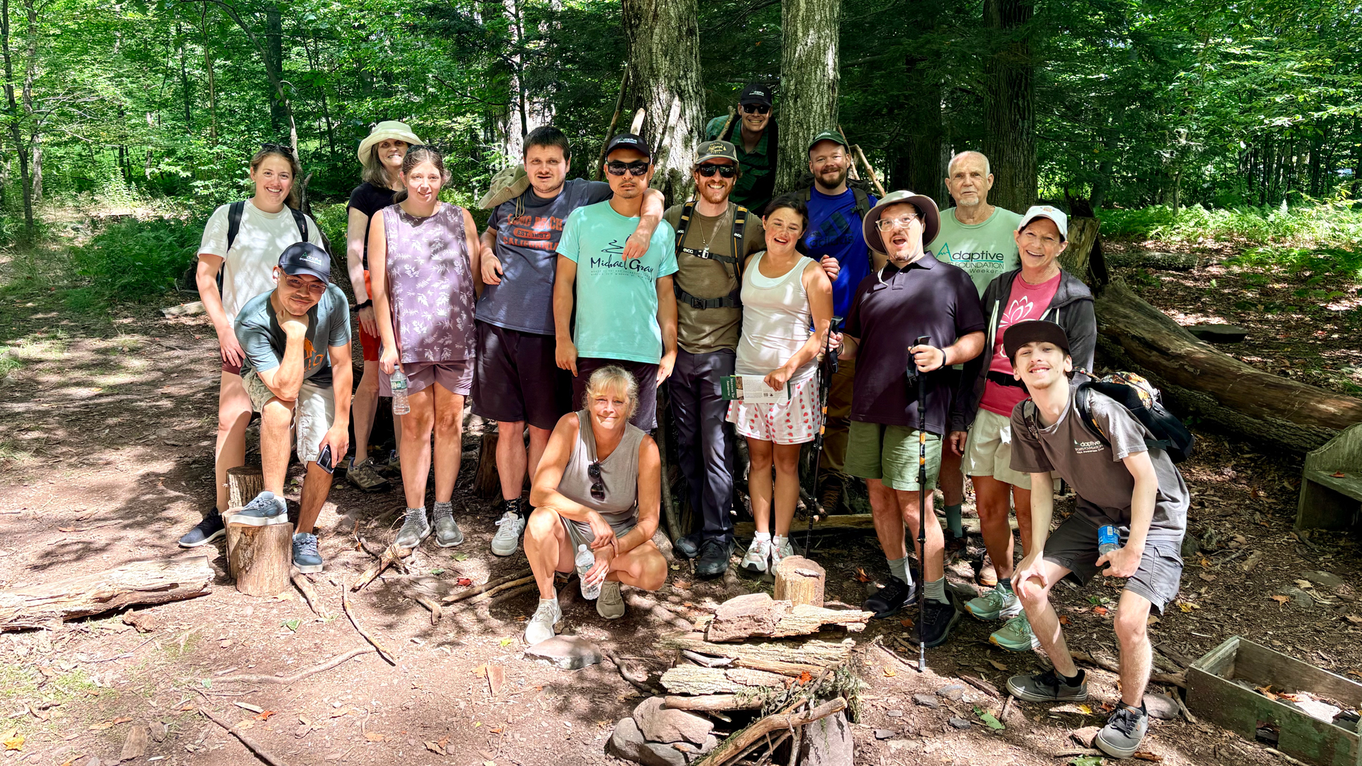 A group of people in the woods smiling at the camera